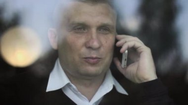 Akıllı telefon kullanarak kafe akıllı telefon üzerinde konuşan adam. Kahve içme