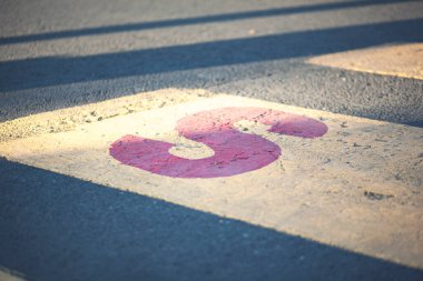 Asfalt üzerinde yeni sarı ve beyaz yaya geçidi S harfiyle.