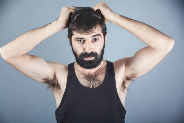 portrait of young man in stress pulling his hair