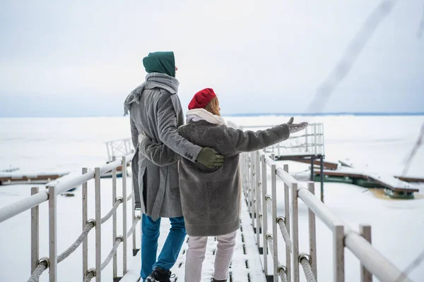 A beautiful woman and a beautiful man left their children at home and went for a walk together along the river on the pier — Stock Photo, Image