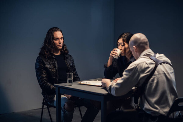 In the interrogation room, the investigator shows the suspect evidence