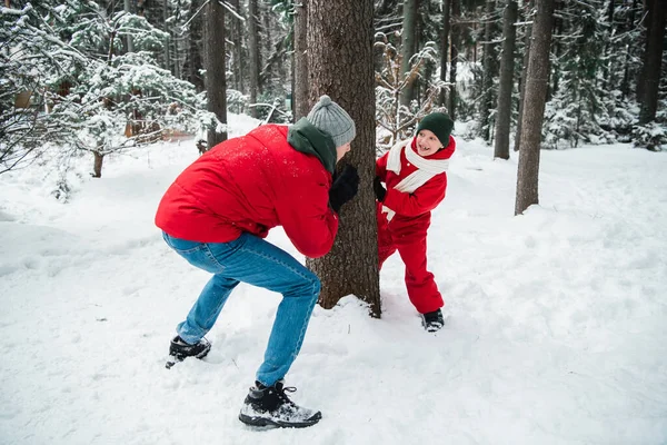 Um jovem pai joga catch up no parque com seu filho fora da cidade em um fim de semana de inverno — Fotografia de Stock