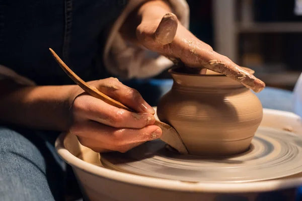 Close-up of the hands of a potter when sculpting a vase from clay on a potters wheel in the workshop. — Stock Photo, Image