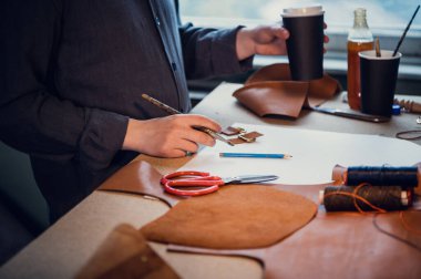 Gerçek deriden yapılmış ayakkabılar üretme süreci. Ayakkabıcıların yüzü olmadan yakın çekim. Sadece eller.