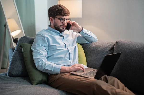 A cute manager works remotely, he puts the laptop on himself and calls his client