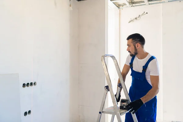 Reparatören använder en lasernivå för märkning — Stockfoto