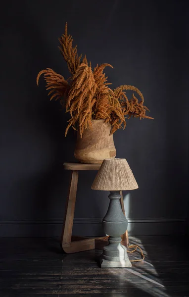 Composição elegante na mesa de madeira com vasos de design com flores de laranja e lâmpada de mesa. Conceito abstrato no interior moderno. — Fotografia de Stock