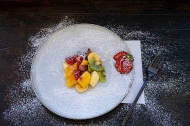 Doğal ve sağlıklı meyve salatası, turuncu seti ve kabuklu bir sunum tabağı. Sağlıklı Gıda Konsepti, Sağlıklı Yaşam. Zirve görünümü.