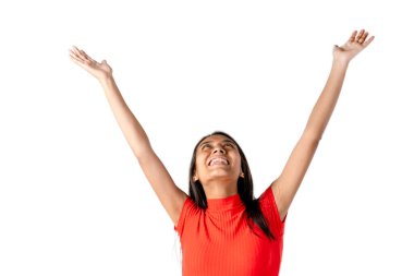 Çekici, koyu renk saçlı, gülümseyen, kollarını açmış saf beyaz bir arkaplana bakan Latin bir kadın..