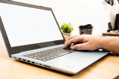 Neutral view of one Man hand at home working on his laptop. He writes on the keyboard. Technology concept.