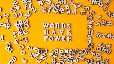 Alıntı kelimelerin parlak sarı arkaplandaki ahşap harflerden yapılmış bir gücü vardır. Motive edici Kelimeler Alıntılar Kavramı