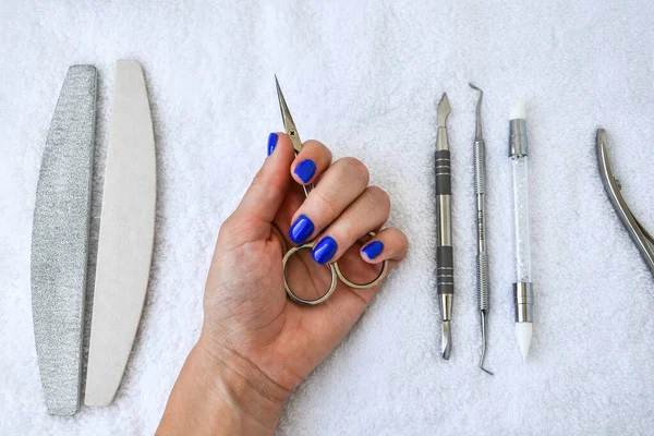 Manicure - tools for creating, gel polishes, all for the treatment of nails, the concept of beauty, care on white towel background. Banner for inscription salon. Copy space for text.