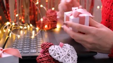 Çevrimiçi alışveriş konsepti, bilgisayar klavyesi kullanan bir kadın. Sevgililer Günü Uluslararası Kadınlar Günü ve Noel Kalpleri hediye kutusu. Hediyeler