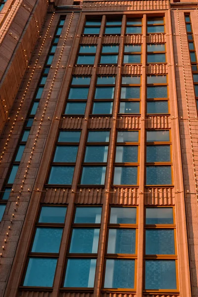 Modern office building, detailed view of finance house windows. Pattern. Office building, blue glass wall reflection detail. Clear sky background. Architecture