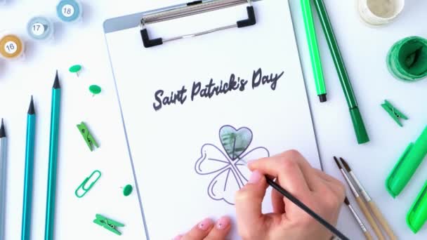Kvinnliga händer målning gratulationskort St Patricks dag. Present idé, inredning hantverk. Gör det själv. Gör det själv. Klöver, pensel och färg. — Stockvideo