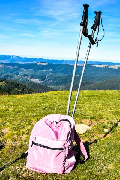 Trekking poles at top of mountain with beautiful view of autumn mountains. Natural background. Hiking. Travel goal concept