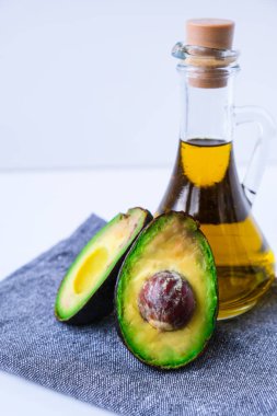 Bir sürahi doğal yağ ve taze olgun hass avokado. Mutfakta yemek hazırlıyorum. Malzemeler. Sağlıklı gıda kavramı. Sağlıklı beslenme. Keto diyeti