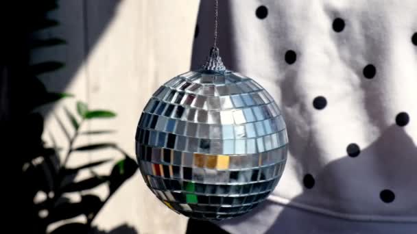 Disco Mirror Ball Spinning. Female hand spin disco ball at home. Sunlight. Daytime — Stock Video