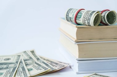 Bilgi zenginliğe götürür. Dolarlı kitap yığını. Pahalı eğitim kavramı. Kitaplardaki para. Üniversite için para biriktiriyorum. Tasarruf, ödenmiş okul ücreti