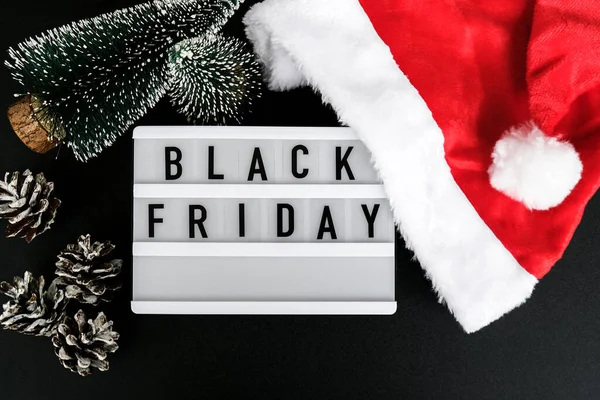 Lightbox with text BLACK FRIDAY around christmas new year decoration. Santas hat. Sale shopping concept. Template Black friday sale mockup fall promotion advertising. Holiday Big sale. Cyber monday.