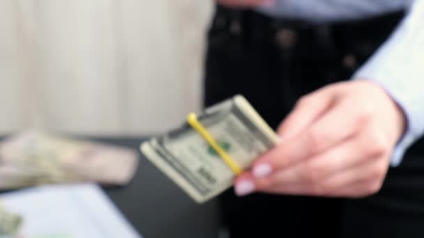 Business Woman Displaying a Spread of Cash US dollars. Close-up. Income and Business concept. Venality, bribe, corruption concept. Hand giving money away. Millennial candid authentic female hands — Stock Video