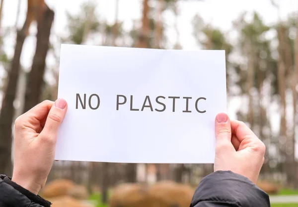 Female Hands Holding White Paper Sheet Text Plastic Outdoors Nature — Stock Photo, Image