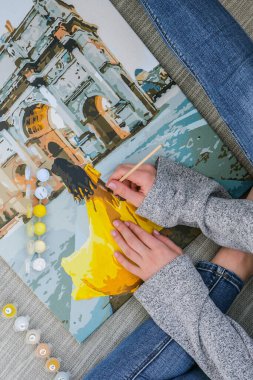 Triumphal Arch Paris 'ten kadın el boyama resmi. Yaratıcı hobi. Yeni başlayanlar için resim yapmak. Evde yalnız kalmak için boş zaman aktivitesi, anti-stres fikri. Meditasyon, rahatlama konsepti