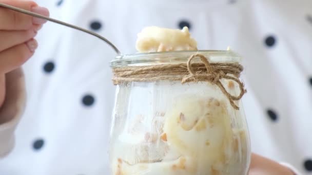 Las manos femeninas, la mujer comiendo desayuno saludable. 4k Granola de avena con yogur griego y nueces de plátano muesli en frasco. Vegano, vegetariano y pérdida de peso concepto de dieta. Menú desintoxicación. — Vídeos de Stock