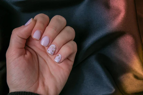 Closeup elegant pastel natural modern design manicure on fabric silk background. Female hands. Gel nails. Nude manicure. Beige color. Skin care. Beauty. Nail care — Stock Photo, Image