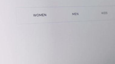 Bilgisayarı kullanarak online mağazadan mal almak. Alışveriş yapmak ve bilgisayardan alışveriş yapmak için Buy düğmesine basmak. Satın alma düğmesine basılıyor. Poşet giysilere ekle. Kara Cuma