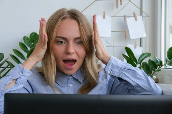 Cansado sonolento jovem caucasiano mulher trabalhador no local de trabalho mesa. Excesso de trabalho e privação do sono. Mulher de negócios e crise monetária. Freelancer em depressão. Mulher triste olhando para um laptop — Fotografia de Stock