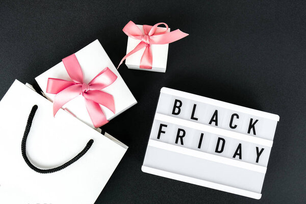 Lightbox with text BLACK FRIDAY with paper shopping bags on dark background, Sale shopping concept. Online shopping Template Black friday sale mockup fall thanksgiving promotion advertising Big sale. Cyber monday. Holiday