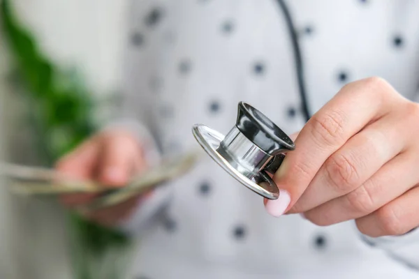 Kadın el ele tutuşması ve steteskop. Tıbbi pahalı ilaç konsepti, doktor maaşı. Uzayı metin için kopyala. Sağlık sigortası. Aşı masrafları. Finansal kriz. Covid-19 suçları