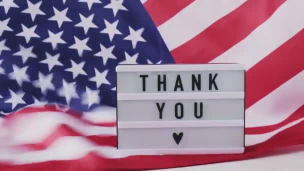 Slow motion zwaaiende Amerikaanse vlag achtergrond. Lightbox met tekst DANK YOU Vlag van de Verenigde Staten van Amerika. 4 juli Onafhankelijkheidsdag. USA patriottisme nationale feestdag. Usa trots. — Stockvideo