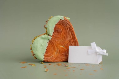 Boş kâğıt şablon Matcha Green Tea aromalı Ganache ile süslenmiş lezzetli taze kruvasan maketi. Eşsiz kalp şekilli fırın. Puf puf böreği, bayram aşkı hediyesi. Sevgililer Günü fikri.