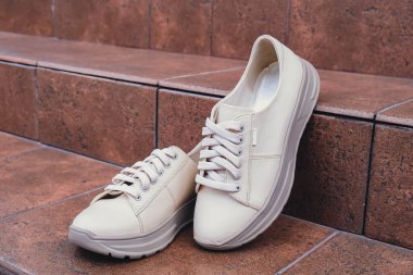 Damgasız bej renkli deri ayakkabılar. Online mağazalar ve sürdürülebilirlik temalı pazarlama için tasarım şablonları. Temiz, boş ayakkabılar. Logo yok.