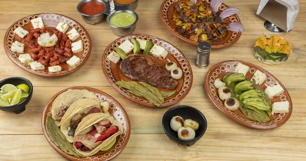 Mexicaans eten geserveerd in klei gerechten, op een houten tafel — Stockfoto