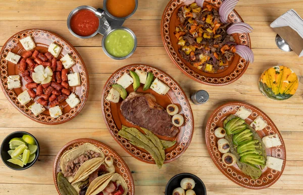 Mexicaans eten geserveerd in klei gerechten, op een houten tafel — Stockfoto