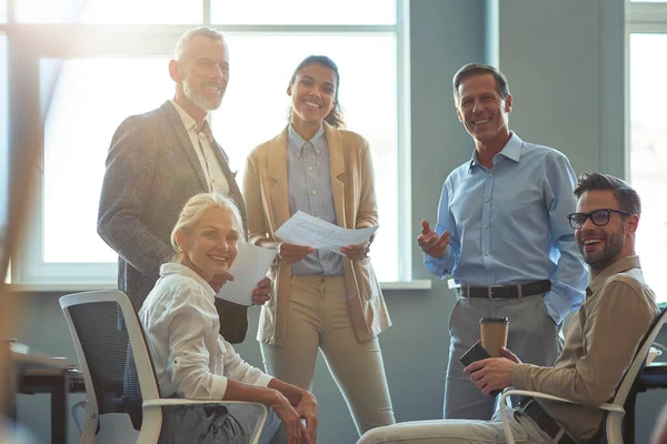 Equipe forte e bem sucedida. Grupo de empresários multirraciais felizes sorrindo para a câmera ao ter uma reunião no escritório — Fotografia de Stock