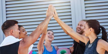 Mutlu karışık yarış takımı duvara yakın beşlik çakıyor.