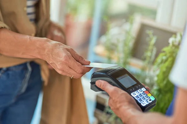 stock image Woman paying with bank card in shop