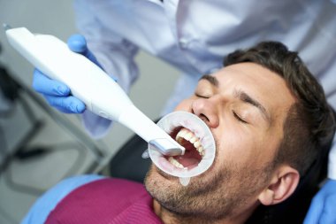 Cropped shot of dental procedure done to a male patient clipart