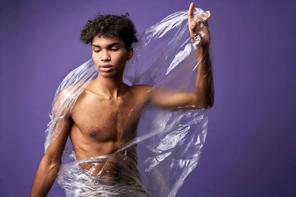 Portrait of young man break plastic bag with athletic hands. Latino transgender male closed eyes — Stock Photo, Image