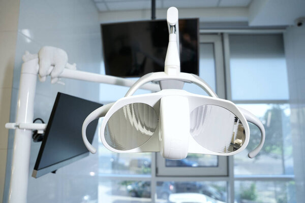 No people photo of dental light on top of dental chair