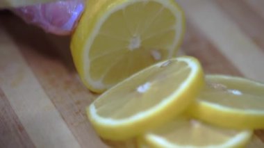 Restoran şefi ahşap kesme tahtasıyla limon keser. Şef eldiven takıyor. HD