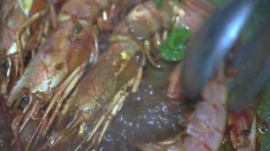 Restoran şefi tavada karides kızartıyor zeytinyağı ve soya sosuyla. HD