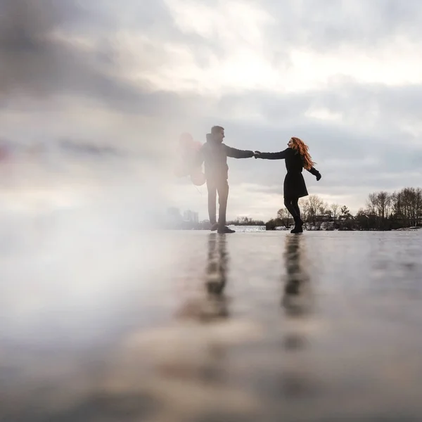 Love couple dance with red balloons outdoor