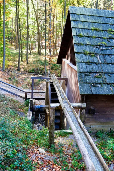 Austria, old water mill covered with wooden shingles and wooden water inlet in natural preserve Sparbach in Unesco World Heritage site of Wienerwald
