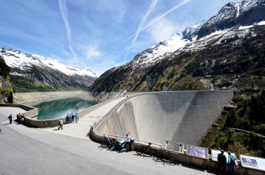 Mayrhofen, Avusturya - 30 Mayıs 2025: Stillup Barajı ve rezervuarında Avusturya Alplerinde yer alan inşaat projesini tanımlayan tabelalarla tanınmayan turistler