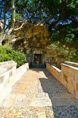 Kos, Greece - September 16, 2025:  Young woman on entrance to medieval Castle Neratzia